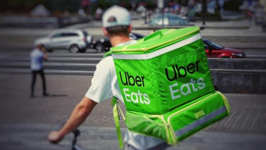 Uber Eats delivery guy on the bike, seen from the back
