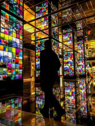 A person walkin among colorful screens