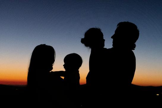 a family of four at the sunset