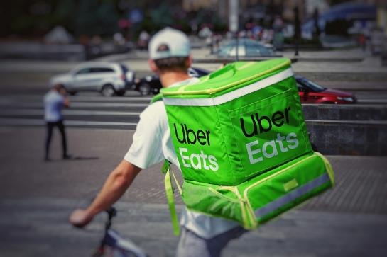 Uber Eats delivery guy on the bike, seen from the back