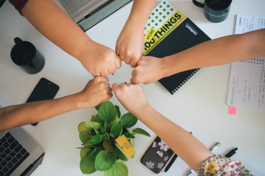 a few hands holding each other