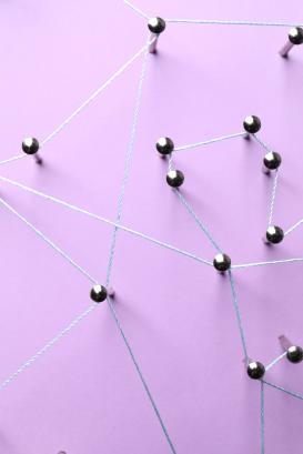 Nails linked together by thread on violet background