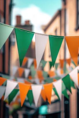 Colorful Irish flags banner hanging across street for St Patrick's Day celebrations.