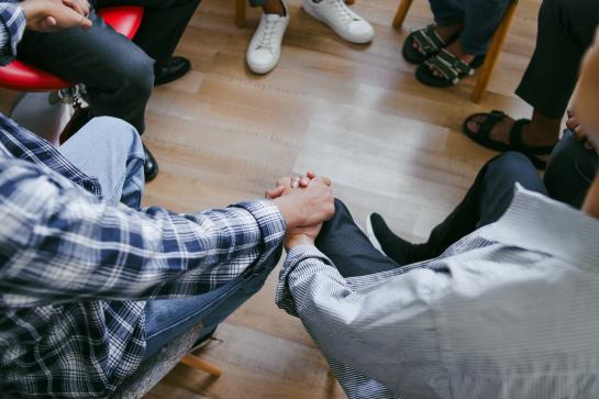 Close Up Of Multi Ethnic People Sit In Circle Hold Hands During Group Therapy Session