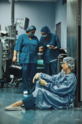Woman surgeon looking sadness fatigue after surgery