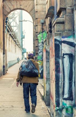 Homeless walking along Manhattan Bridge, New York City 